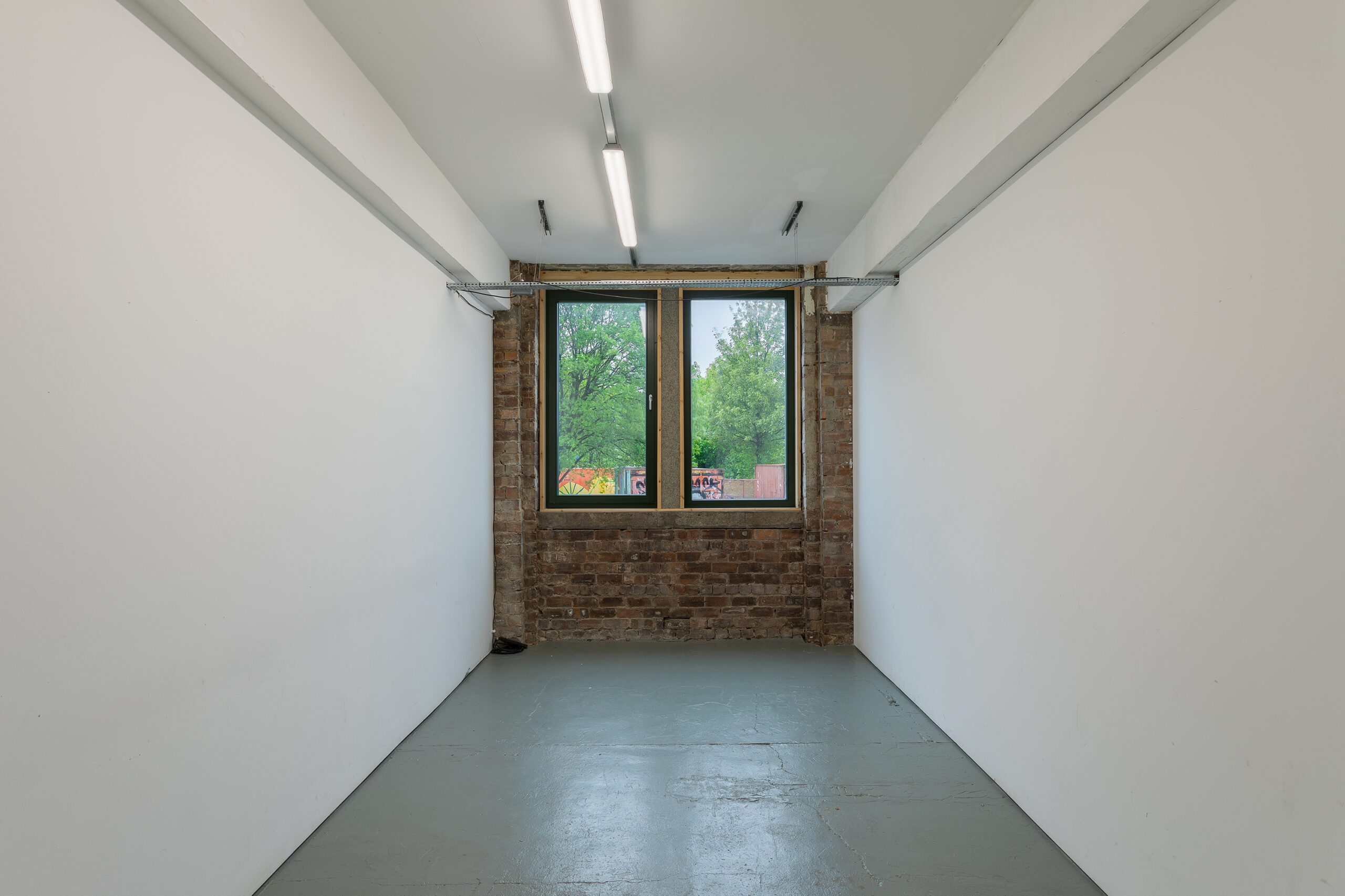 Photo of the project space at Civic House looking towards the street. This can be used as the ticket booth and check-in desk for the Festival hub as it is a small white box placed conveniently between the venue and the canteen.