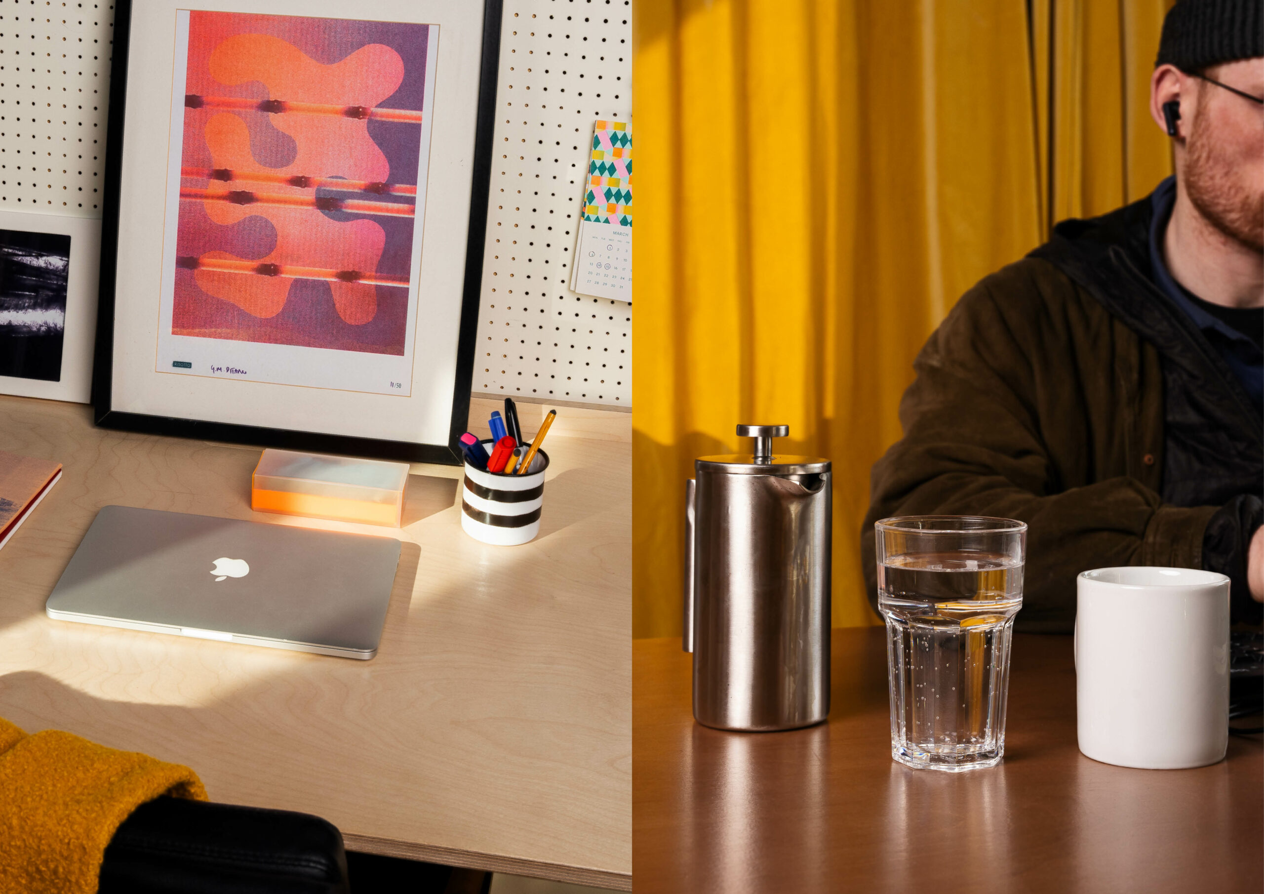 A split image of the fixed desk and a hot desk at Civic House. On the left is a view of an office set up at the fixed desk with a MacBook, a cup of pens, and posters hung on the peg board. On the right is a cafetiere, a glass of water, and a mug sitting on one of the hot desks with a partial shot of a coworking member at their laptop.